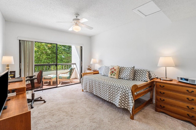 carpeted bedroom with a textured ceiling and ceiling fan