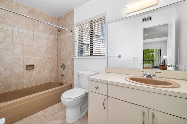 full bathroom featuring vanity, toilet, tiled shower / bath combo, and tile patterned floors