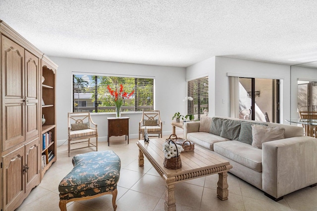 living room with light tile patterned flooring and a textured ceiling