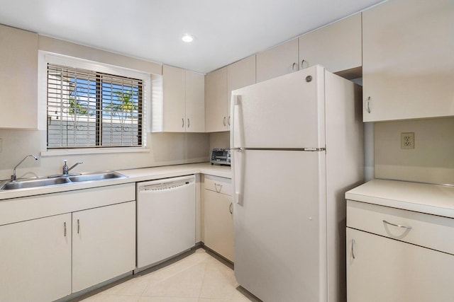 kitchen with white appliances, light tile patterned floors, and sink