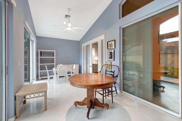 dining room featuring ceiling fan, light tile patterned floors, and lofted ceiling