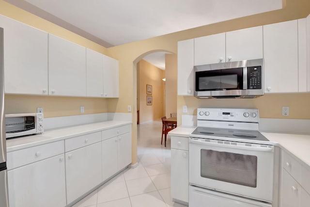 kitchen featuring white cabinets, white range with electric cooktop, and light tile patterned flooring