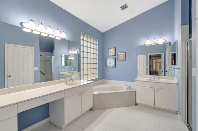 bathroom featuring independent shower and bath, tile patterned flooring, and vanity