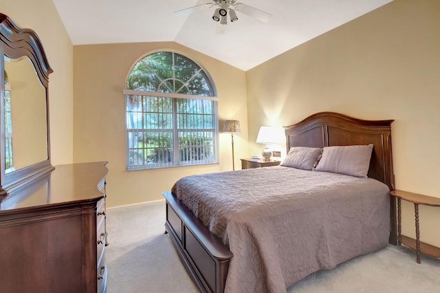 bedroom featuring ceiling fan, lofted ceiling, and light colored carpet