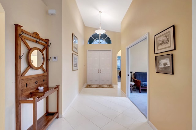 tiled foyer with high vaulted ceiling