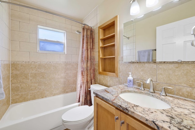 full bathroom featuring shower / bath combination with curtain, tile walls, decorative backsplash, vanity, and toilet