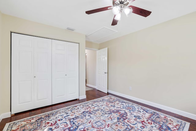 bedroom featuring ceiling fan, a closet, and dark hardwood / wood-style flooring