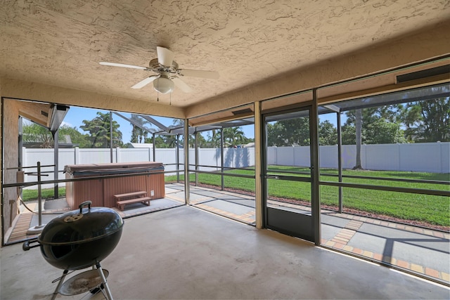 unfurnished sunroom with ceiling fan