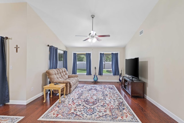 living room with dark hardwood / wood-style flooring, ceiling fan, and high vaulted ceiling