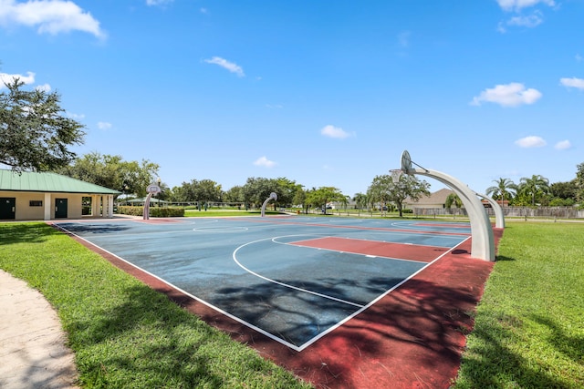 view of sport court featuring a yard