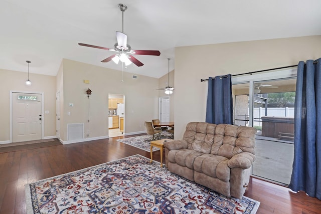 living room with vaulted ceiling, ceiling fan, and dark wood-type flooring