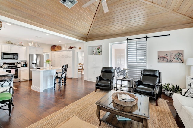 living room with ceiling fan, wood ceiling, dark hardwood / wood-style floors, a barn door, and vaulted ceiling