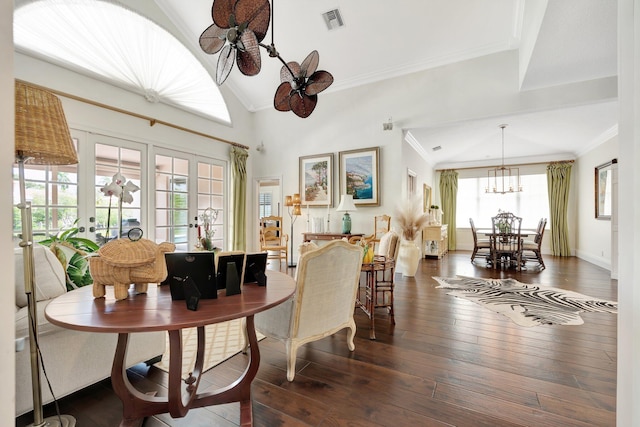 dining area with french doors, an inviting chandelier, crown molding, and dark hardwood / wood-style flooring