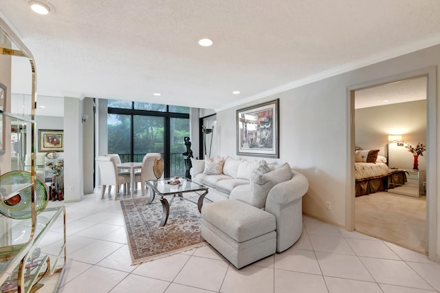 tiled living room featuring a textured ceiling, floor to ceiling windows, and ornamental molding