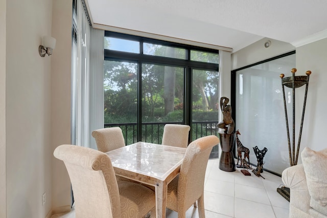 dining room featuring light tile patterned floors and ornamental molding