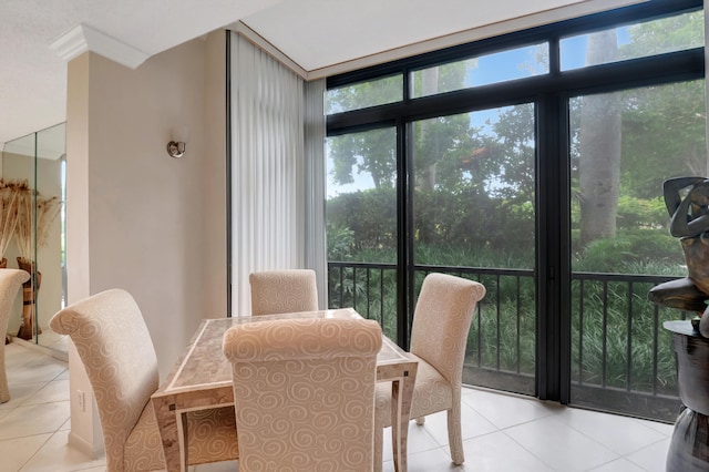 tiled dining area with ornamental molding and floor to ceiling windows