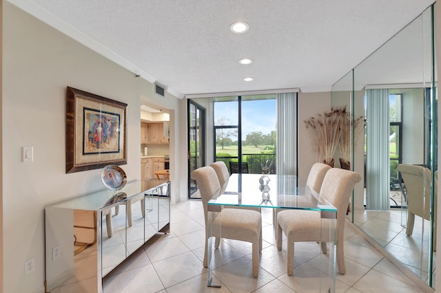 tiled dining area featuring a textured ceiling, crown molding, and a wall of windows