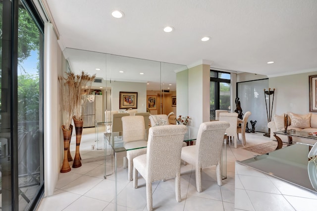 dining room with crown molding, light tile patterned floors, and a wealth of natural light