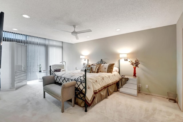 carpeted bedroom featuring a textured ceiling and ceiling fan