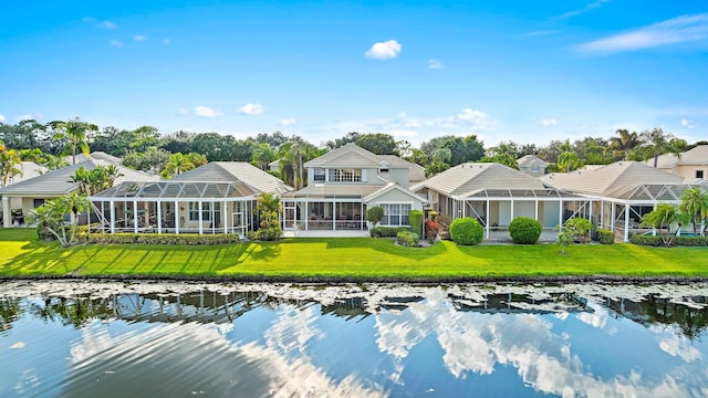 back of property featuring a lawn, a water view, a sunroom, and glass enclosure