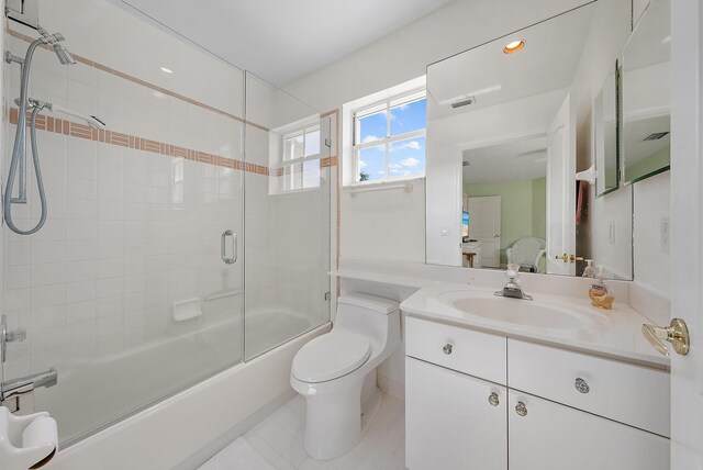 full bathroom featuring enclosed tub / shower combo, tile patterned flooring, vanity, and toilet