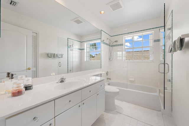 full bathroom featuring vanity, tile patterned floors, toilet, and a wealth of natural light