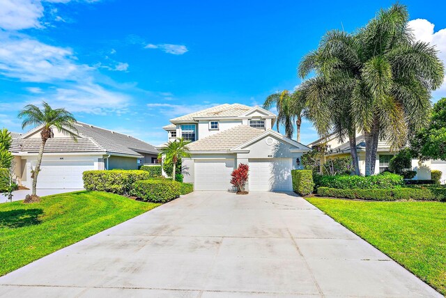 front of property with a garage and a front yard