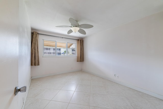 tiled empty room with ceiling fan