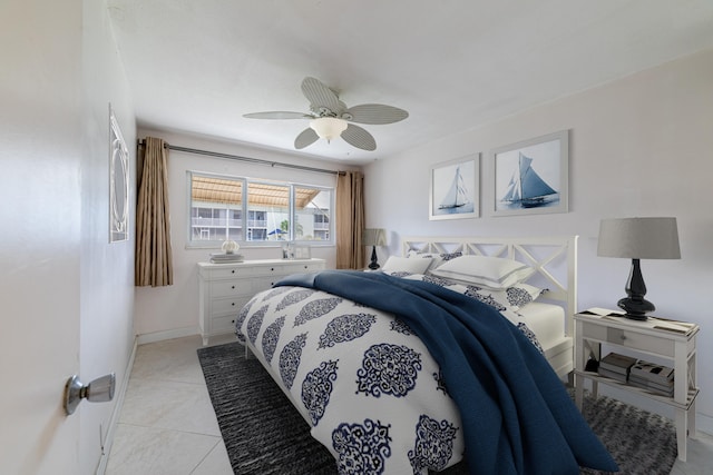 tiled bedroom featuring ceiling fan