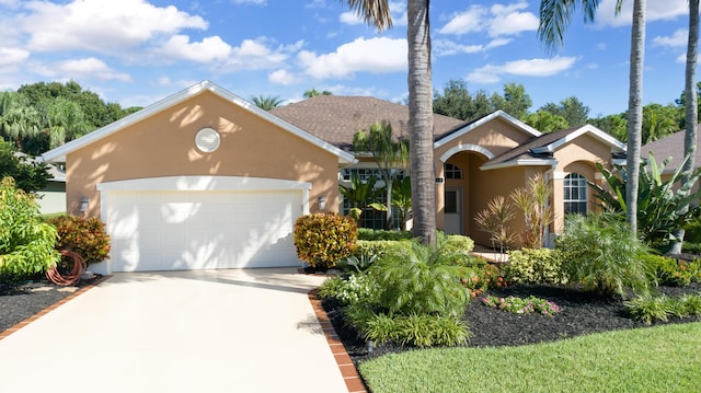 ranch-style house featuring a garage, concrete driveway, and stucco siding