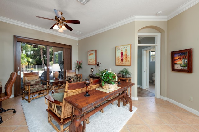 interior space featuring crown molding, light tile patterned flooring, and ceiling fan