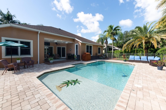 view of pool featuring a fenced in pool, a ceiling fan, a patio, fence, and outdoor lounge area