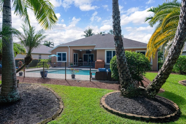 view of pool with a patio, a lawn, fence, and a fenced in pool