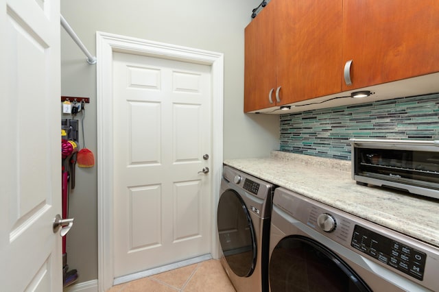 laundry area with cabinet space, a toaster, light tile patterned floors, and separate washer and dryer