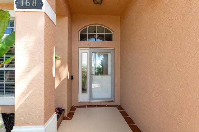 property entrance with stucco siding