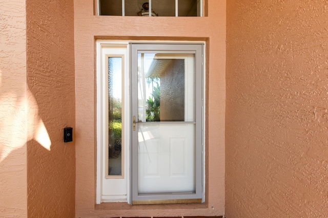 entrance to property with stucco siding