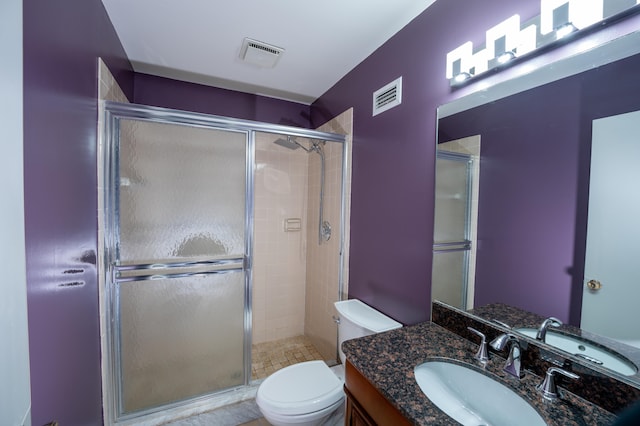 bathroom with vanity, toilet, and an enclosed shower