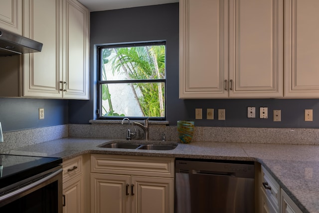 kitchen featuring light stone countertops, range hood, stainless steel appliances, and sink