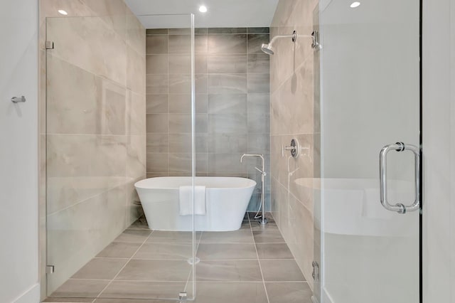 bathroom with independent shower and bath, tile walls, and tile patterned floors