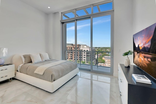 bedroom featuring expansive windows and access to exterior