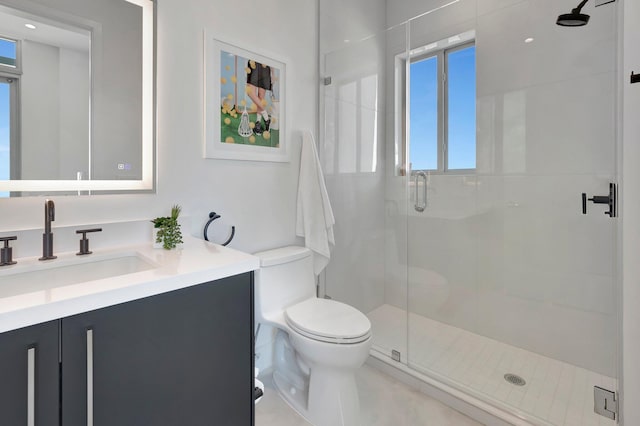 bathroom with tile patterned flooring, walk in shower, vanity, and toilet