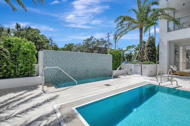 view of swimming pool featuring a patio area