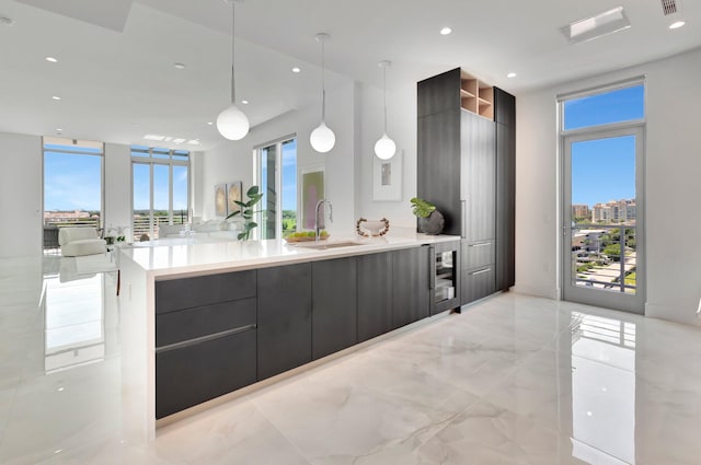 kitchen with pendant lighting, a wealth of natural light, and sink