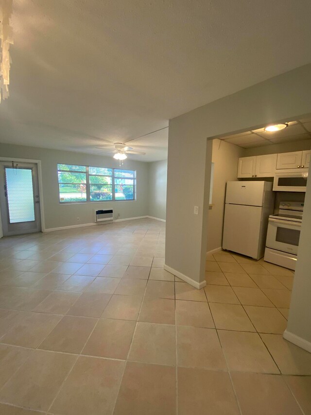 interior space featuring ceiling fan and a wall mounted air conditioner