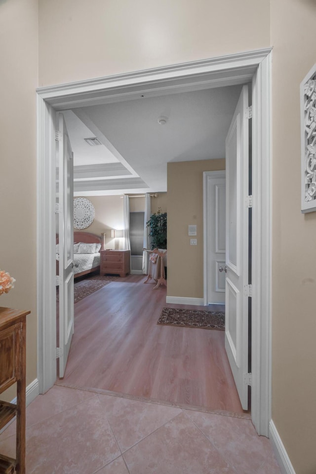 hallway with light hardwood / wood-style floors