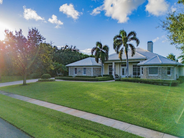 ranch-style home featuring a front yard