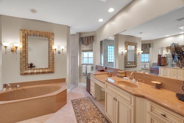 bathroom with vanity, a relaxing tiled tub, and tile patterned floors