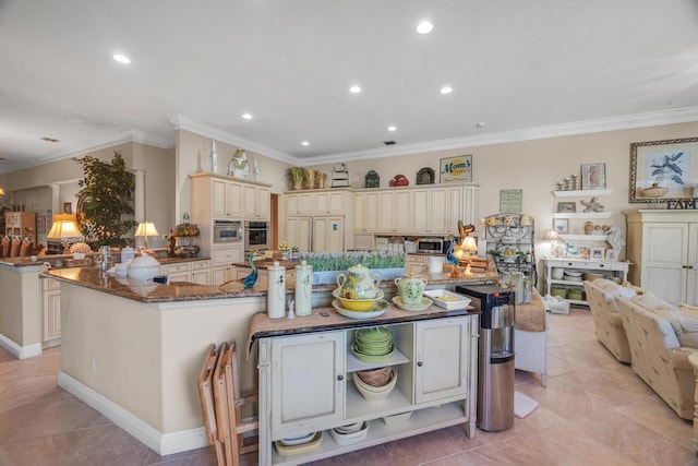 kitchen featuring ornamental molding, stainless steel oven, and kitchen peninsula