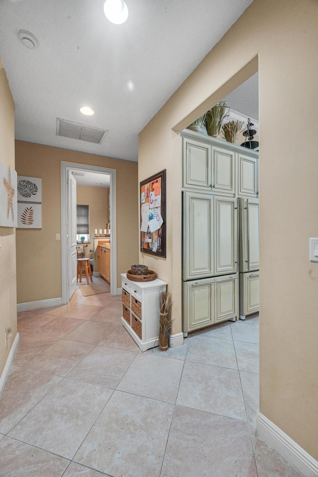 hallway with light tile patterned floors