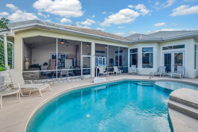 view of pool featuring a patio, ceiling fan, and a sunroom